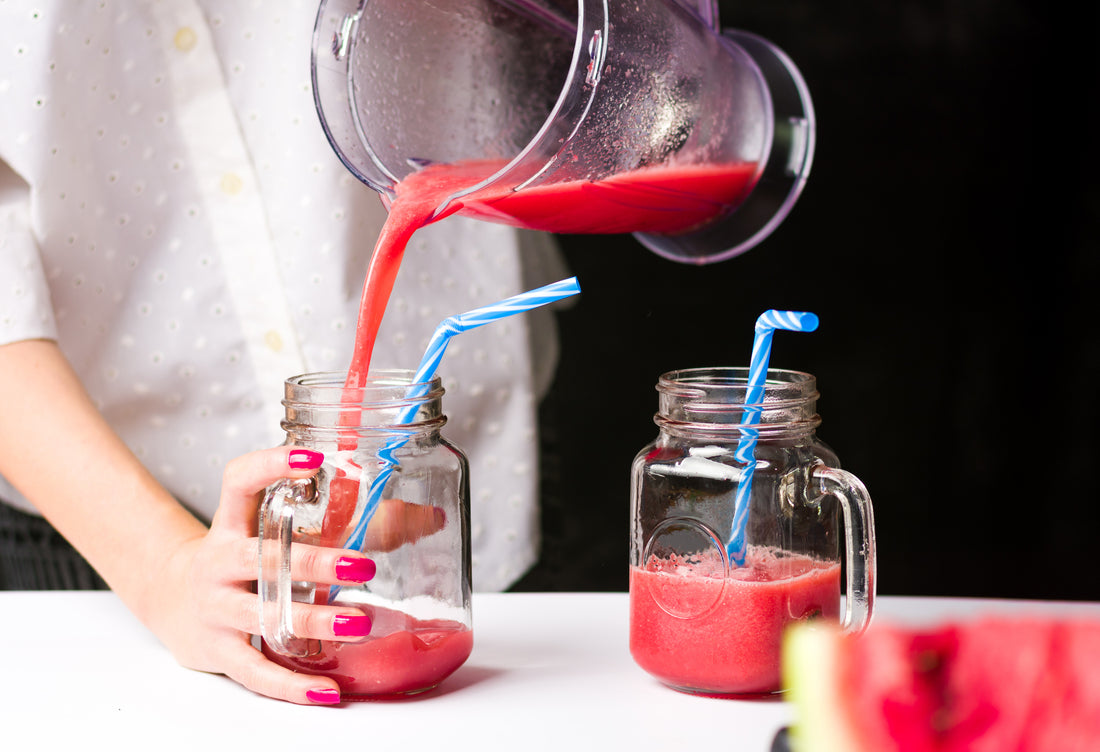 Bartender pouring fruit juice from a blender