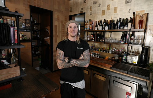 Person standing with arms crossed in a kitchen