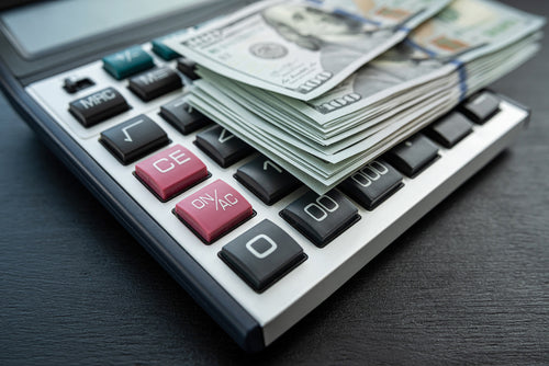 Stack of dollars on Calculator