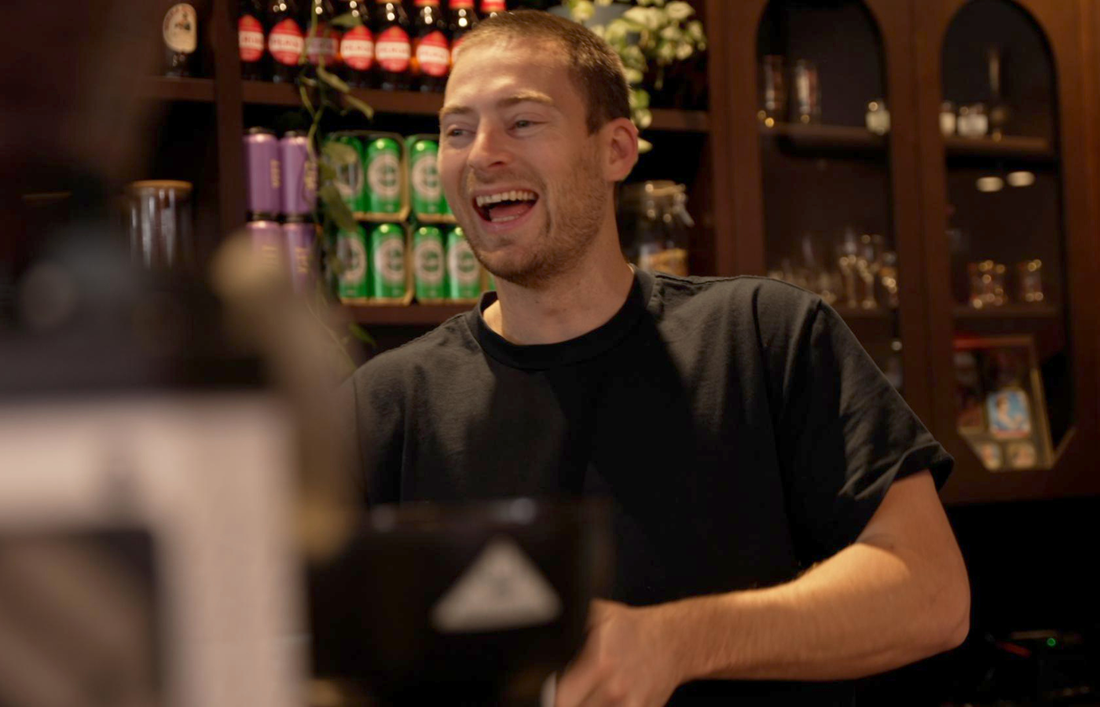 Man smiling working at restaurant